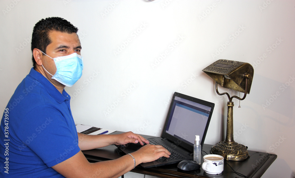 latin man with protection mask and antibacterial gel, working in home office and drinking coffee, new normal
latin man with protection mask and antibacterial gel, working in home office and drinking coffee, new normal