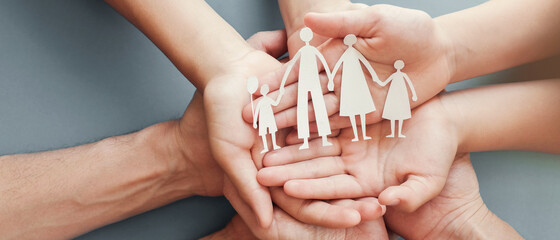Adult and children hands holding paper family cutout, family home, foster care wellness, homeless charity support, family mental health, budget cost of living concept