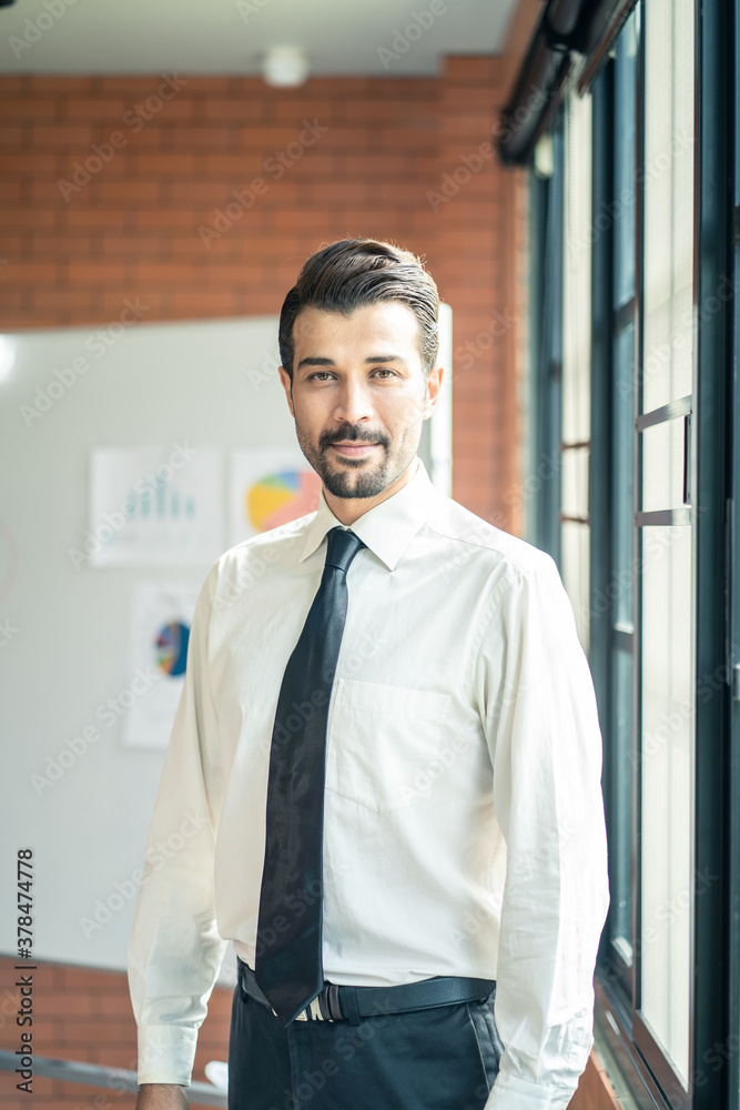 Caucasian businessman standing and smile in meeting room in office. Caucasian businessman standing and smile in meeting room in office.
