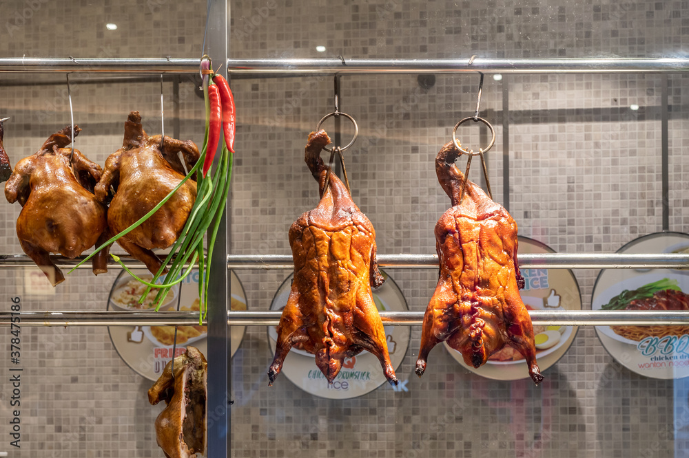 Naklejka premium Two Delicious Homemade Roasted ducks hung in kitchen