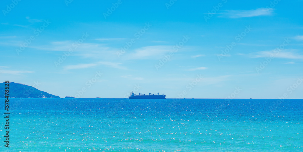 Beauty panorama skyline in pure blue azure sea, clear sky background, empty sea only sailing vessel ship on the skyline horizon. Navy is always on guard even in times of peace. For design wallpaper Beauty panorama skyline in pure blue azure sea, clear sky background, empty sea only sailing vessel ship on the skyline horizon. Navy is always on guard even in times of peace. For design wallpaper
