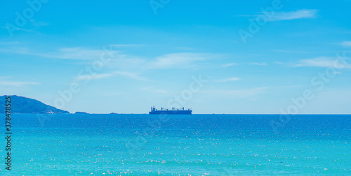 Beauty panorama skyline in pure blue azure sea, clear sky background, empty sea only sailing vessel ship on the skyline horizon. Navy is always on guard even in times of peace. For design wallpaper © NOVOZHILOV ANDREI