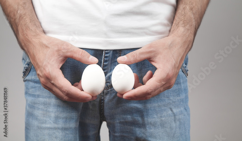 Caucasian man showing two eggs.