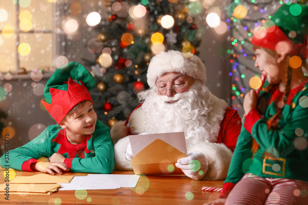Elf kids with Santa Claus reading letter at home Elf kids with Santa Claus reading letter at home