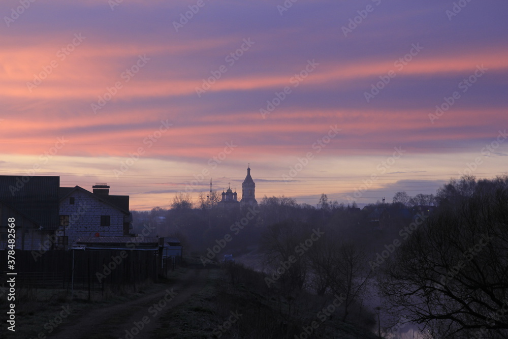 Landscape with the church silhouette in an early morning in April