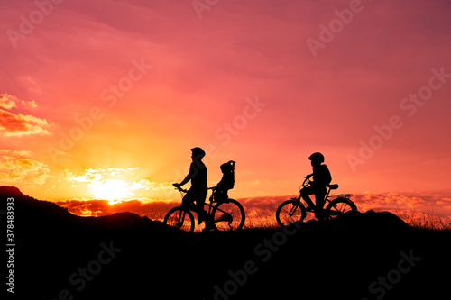father riding a bike with family members