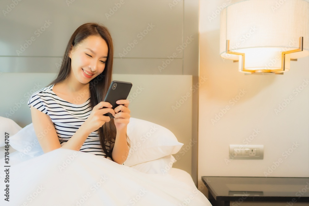 Portrait beautiful young asian woman use smart mobile phone on bed Portrait beautiful young asian woman use smart mobile phone on bed