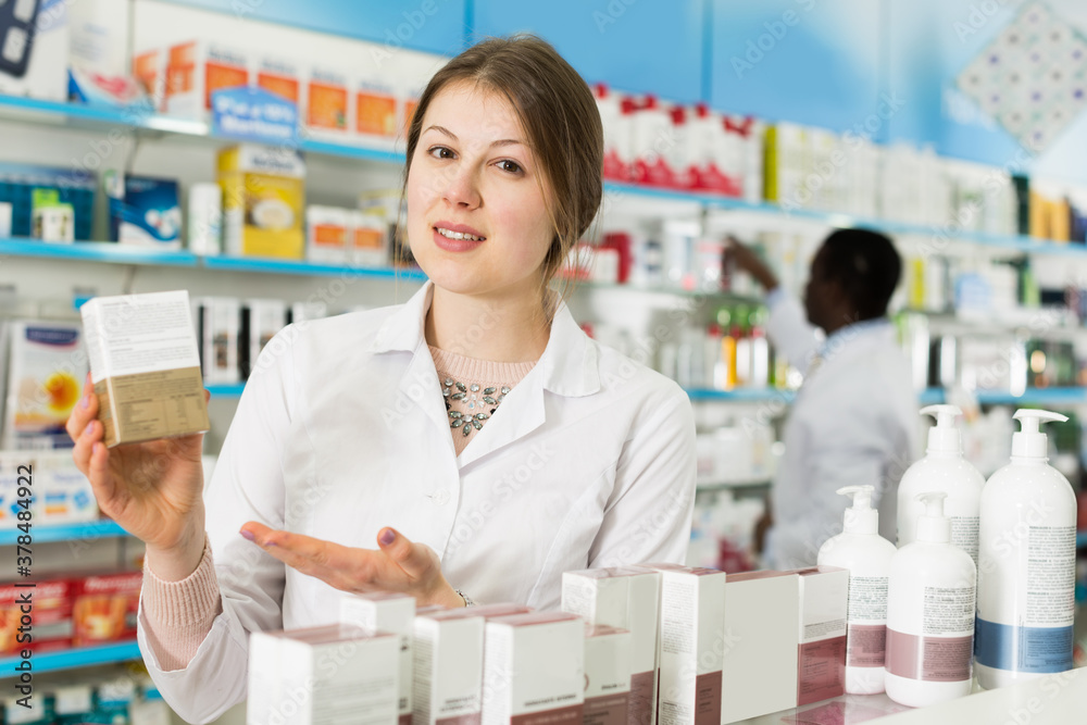 Portrait of experienced female pharmacist counseling about medicines in pharmacy