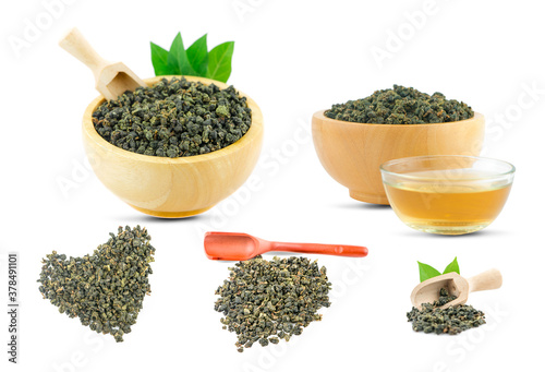 Dry green oolong tea in wooden bowl an isolated on white background with clipping path