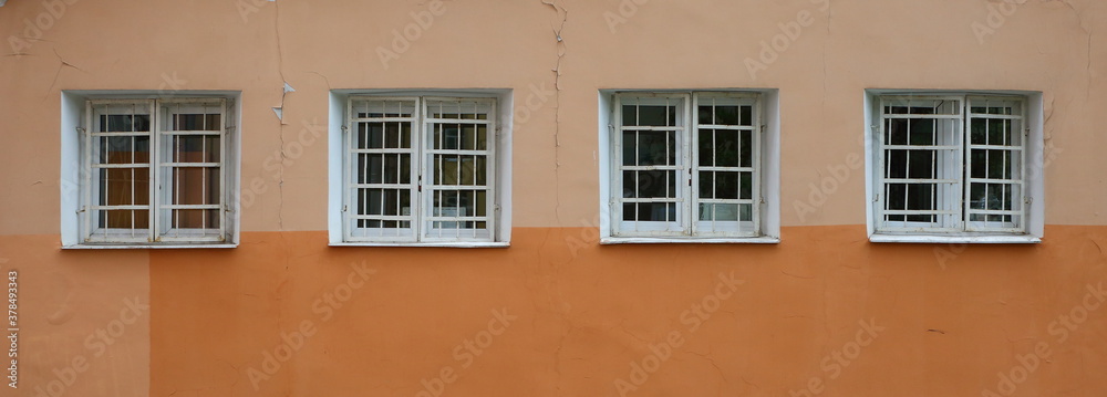 A four square windows with a metal barrier
