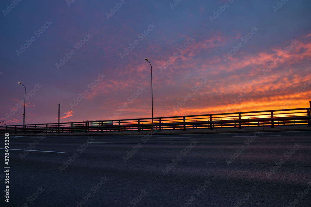 express road leading through the city during sunrise, perfect as a backplate for rendering e.g. cars