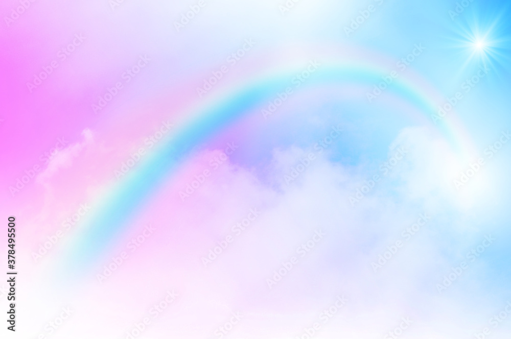 The Rainbow sky is Colorful sky with Soft clouds and a rainbow crossing. Fantasy magical sunny sky pastel background is fluffy white cloud. Freedom wallpaper concept. Sweet color dream.