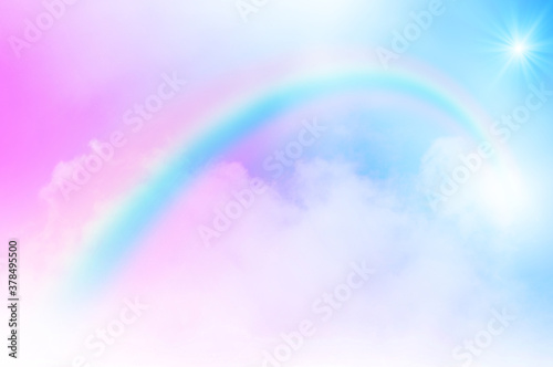 The Rainbow sky is Colorful sky with Soft clouds and a rainbow crossing. Fantasy magical sunny sky pastel background is fluffy white cloud. Freedom wallpaper concept. Sweet color dream. © kikk