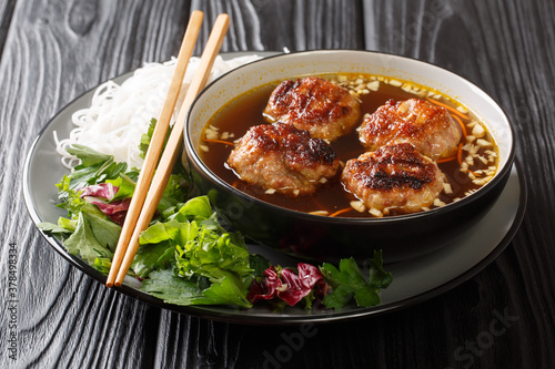 Vietnamese Grilled Pork Meatballs with Vermicelli Noodles Bun Cha is a classic Northern Vietnamese dish closeup in the plate on the table. Horizontal