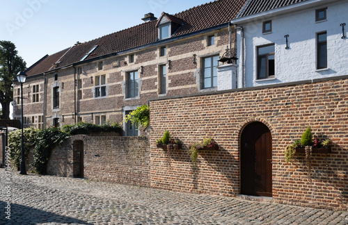 Restored houses at the Begijnhof or Beguinage in the streets of Tongeren, the oldest town in Belgium photo
