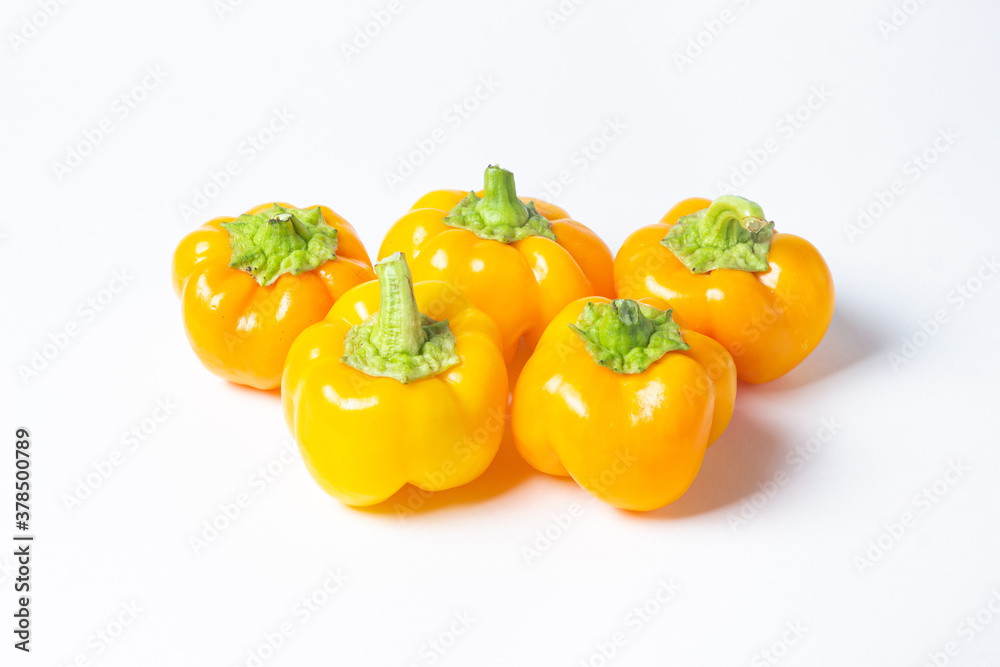 yellow pepper on a white background. Several yellow peppers lie next to each other. Healthy vegetables yellow pepper on a white background. Several yellow peppers lie next to each other. Healthy vegetables