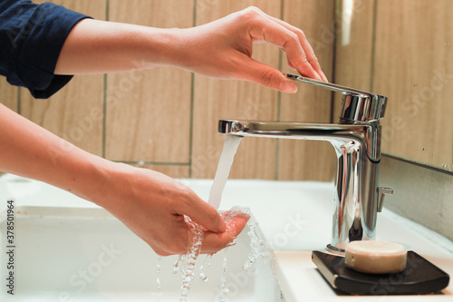 Woman washes hands in bathroom. Hygiene  virus control concept. Coronavirus Control.