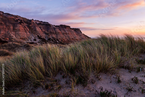 Winter dawn on the beach at the foot of the cliffs of Hengistbury head near Bournemouth in Dorset south west England photo