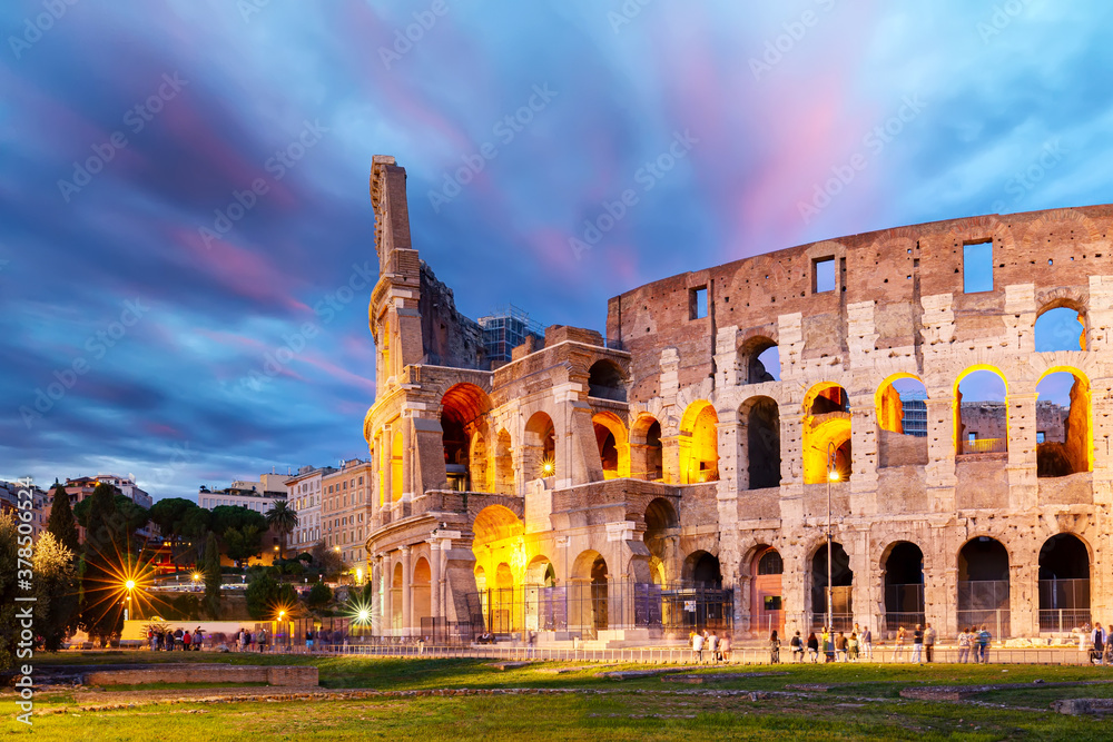 The Colosseum in Rome, Italy at colorful sunset twilight. The world famous colosseum landmark in Rome.