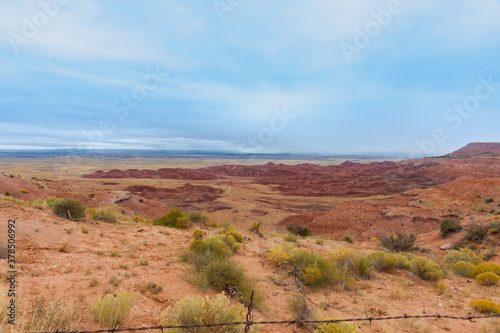 Utah landscape of flat land with red rock outcrop in foreground