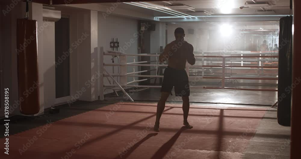 Boxing, athletic man fighter trains his punches, training day in the boxing gym. Boxing, athletic man fighter trains his punches, training day in the boxing gym.