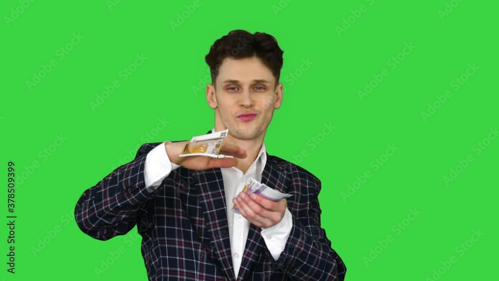 Wealthy businessman throwing money in air on a Green Screen, Chroma Key. Wealthy businessman throwing money in air on a Green Screen, Chroma Key.