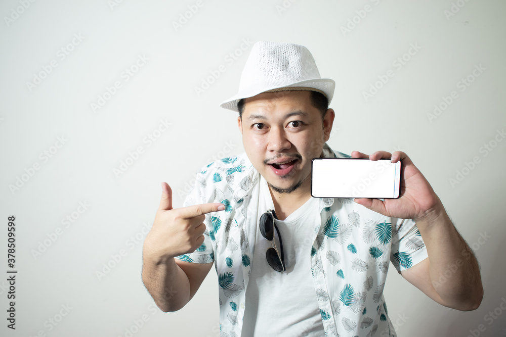 Portrait of a smiling young man with using smartphone isolated on a white background
Holiday traveler concept Portrait of a smiling young man with using smartphone isolated on a white background
Holiday traveler concept