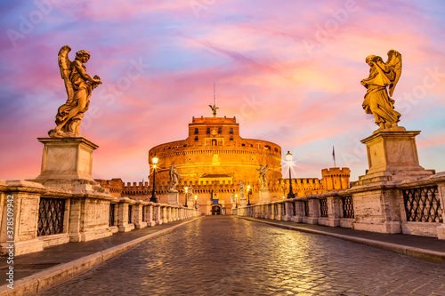 Castel Sant'Angelo and the Sant'Angelo bridge during twilight sunset in Rome, Italy