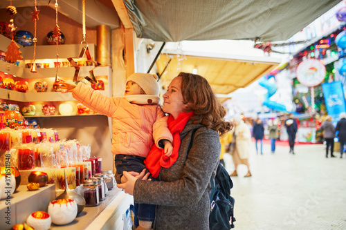 Woman and adorable toddler girl on Christmas market in Paris, France © Ekaterina Pokrovsky