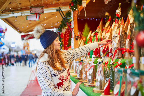 Photography woman buying holiday decorations on traditional Christmas market in Paris, Franc