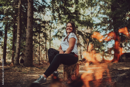 young woman enjoying nature, picnicking in nature, walking in the forest enjoying the sunset