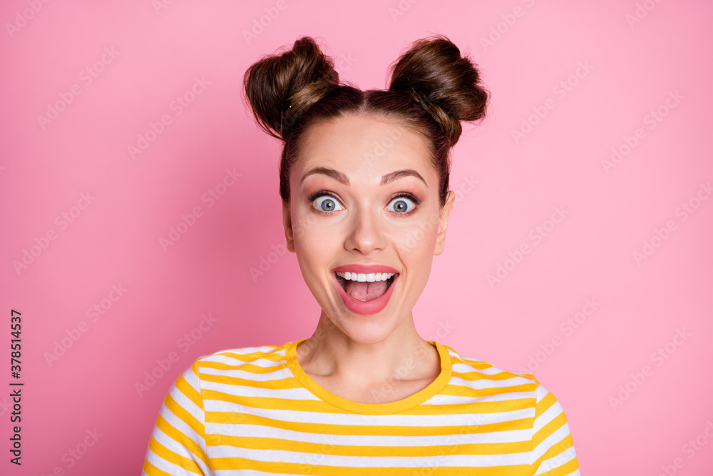 Closeup photo of attractive pretty shocked lady two funny buns cheerful mood listen amazing good news wear casual white yellow striped shirt isolated pink color background