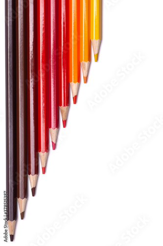 multi-colored wooden pencils in red shades on a white isolated background, autumn colors, mock up, vertical.