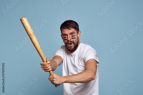 emotional man with a bat in his hand on a blue background and makeup on his face black lines energy t-shirt baseball