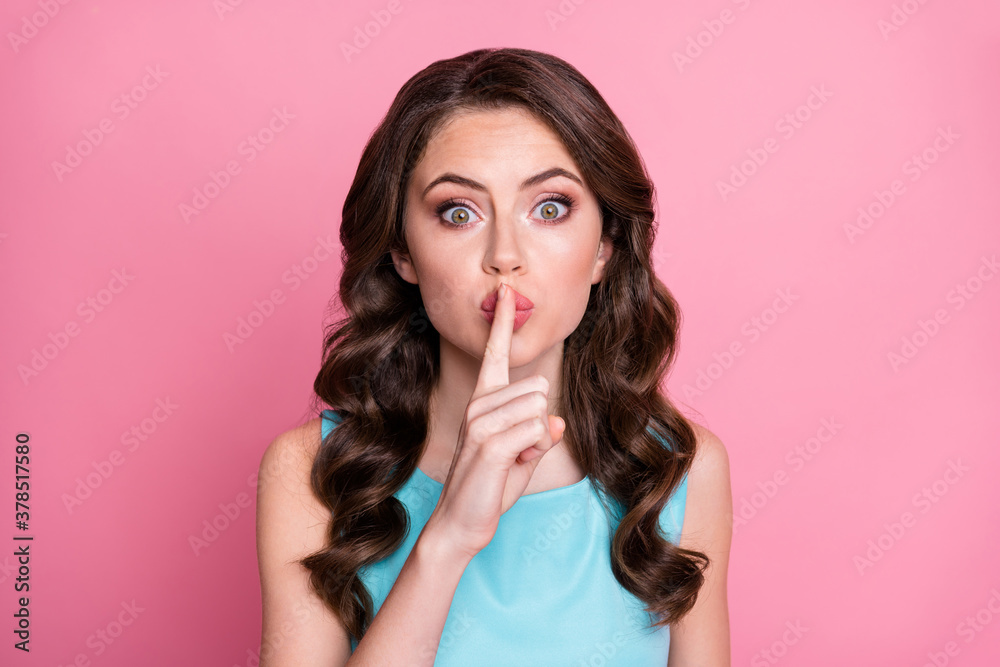 Naklejka premium Closeup photo of attractive charming wavy lady birthday event festive party hold finger on lips mouth ask keep silence arrange surprise friend wear blue dress isolated pink color background