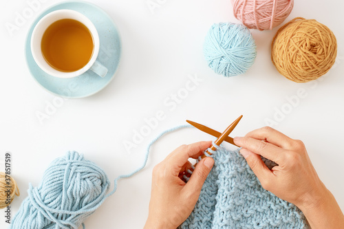 Woman hands knitting hat with needles and yarn photo