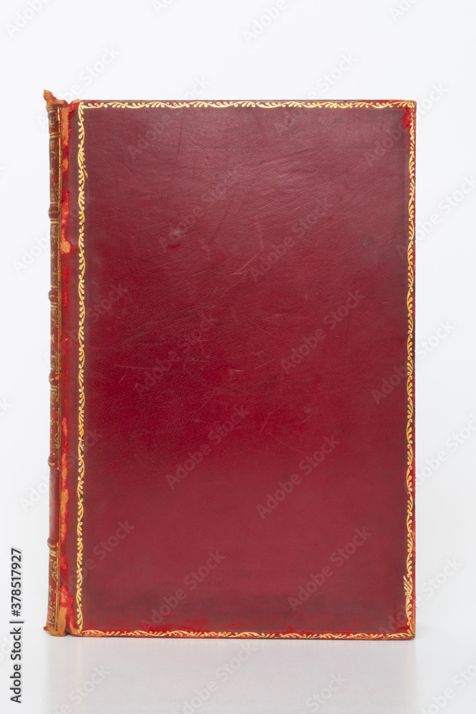 Fototapeta premium old red leather book isolated on white