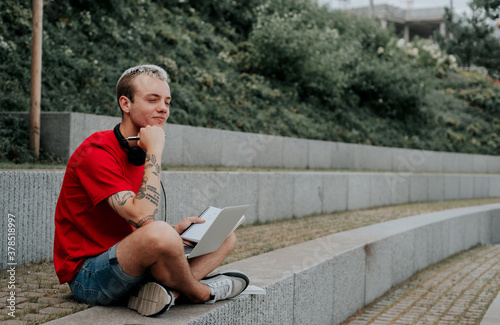 young man listening to music in the park
