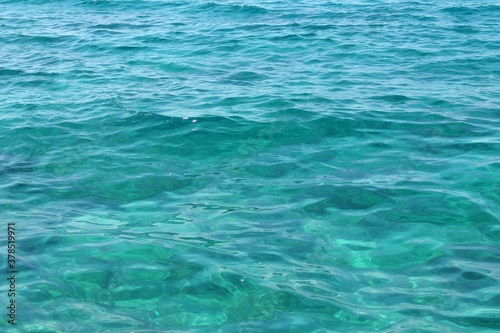 transparent calm turquoise sea surface background
