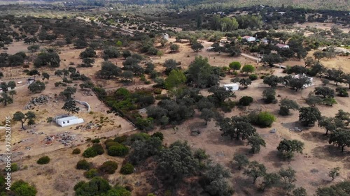 Aerial images over a Mediterranean forest area with small rural buildings photo