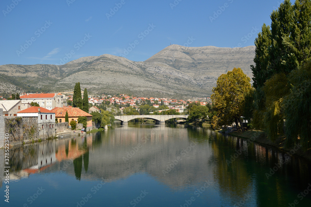 Fototapeta premium View of Old Town of Trebinje on the bank of Trebisnjica river in a sunny day, Bosnia and Herzegovina