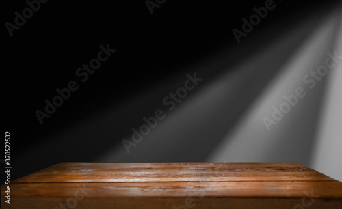 Old wooden table top with smoke on a dark background..