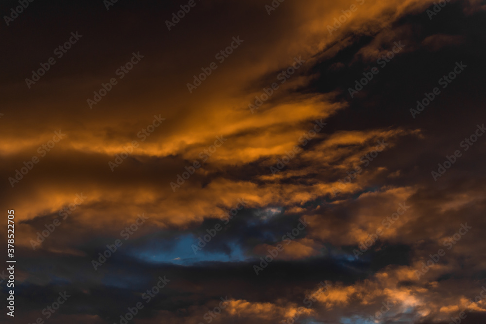 evening bright yellow orange red sunset with clouds in the sky