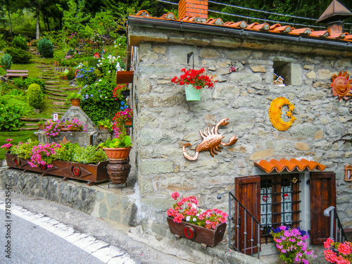 colorful house and garden in Pian dei Sisi on the way to Cutigliano, Pistoia, Abetone, Italy, Europe photo