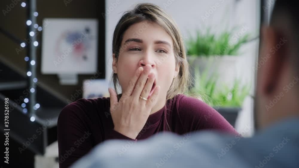 Bored woman yawning while man talks. Young people having boring conversation at home. Wife and talkative husband speaking on sofa. Married partners and relationship problems Bored woman yawning while man talks. Young people having boring conversation at home. Wife and talkative husband speaking on sofa. Married partners and relationship problems