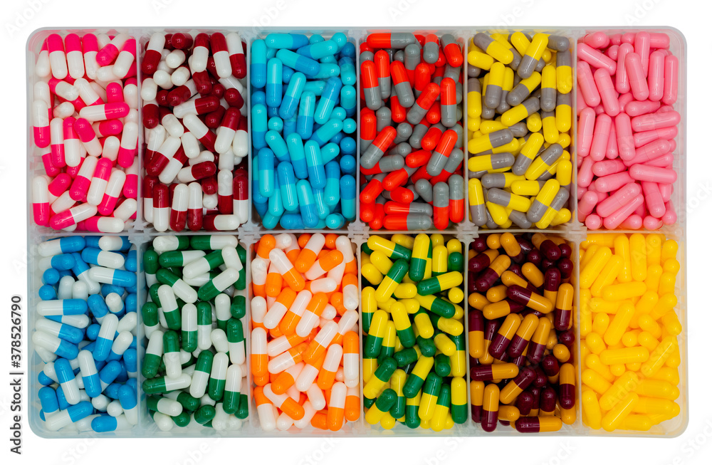 Top view of colorful capsule pills in  plastic box. Antibiotic drugs, painkiller medicine, vitamins, and supplements capsule pills. Pharmaceutical industry. Infections. Capsule pills production.