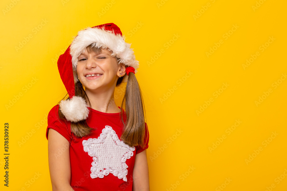 Little girl wearing Santa hat winking Little girl wearing Santa hat winking