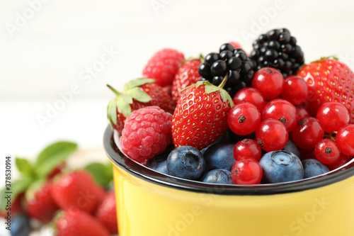 Mix of ripe berries in mug  closeup