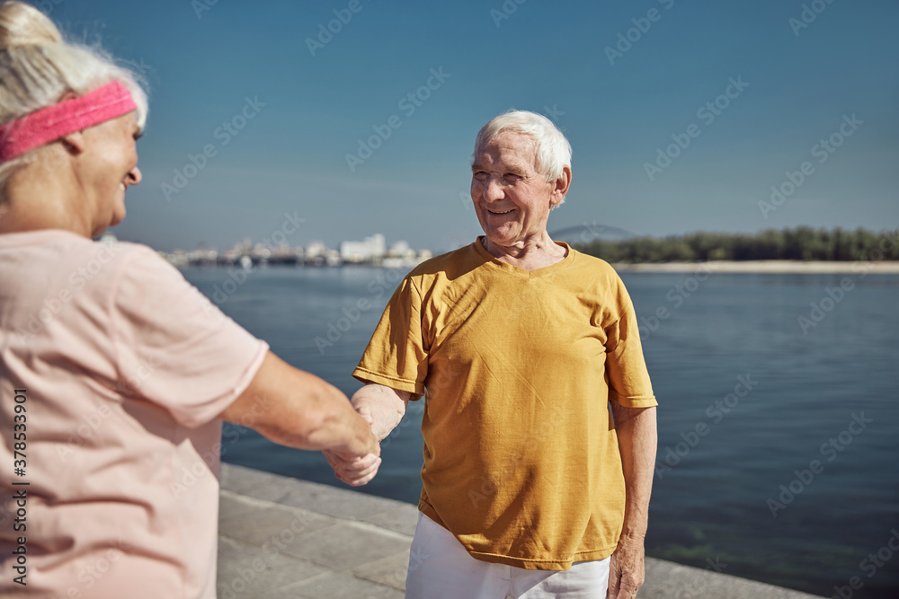 Woman greeting a man on the quay Woman greeting a man on the quay