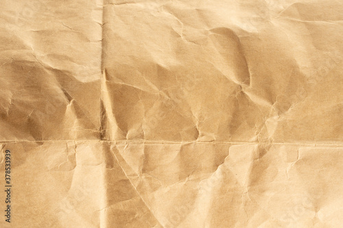 Craft paper.  Crumpled brown cardboard paper texture. Old Crumpled recycled paper texture  color beige. Brown background